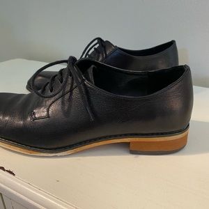Black leather Oxford shoes.